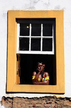 painted women at a window of the unesco world heritage city of ouro preto in minas gerais brazil