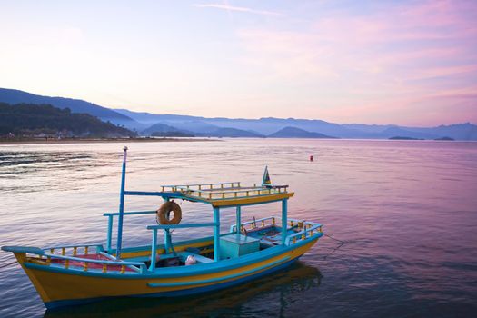 colorful boat at sunset in the bay of beautiful portuguese colonial typical town of parati in rio de janeiro state brazil