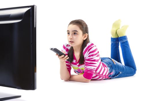 little girl watching LED tv laying on white background