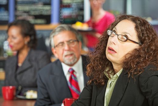 Annoyed business woman next to man in coffee house