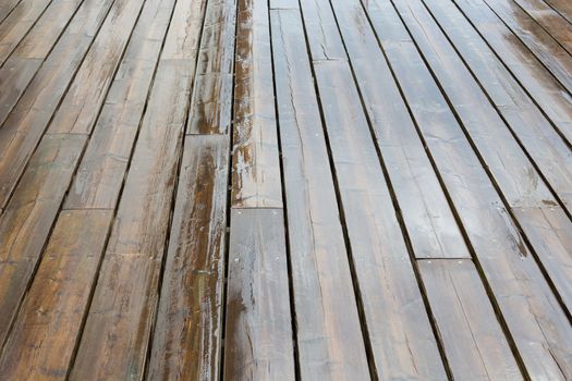 Wet wooden planks background pattern on a rainy day