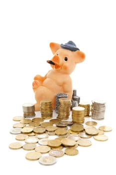 Funny piggy bank and piles of coins over white background