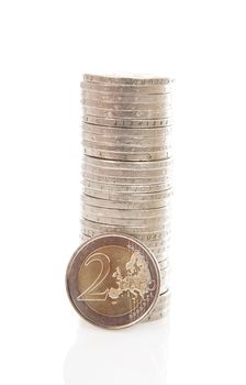 Piles of 2  Euro money coins over white background