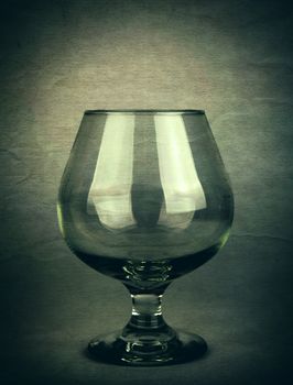 Vintage and Toned Photo of the Glass on Dark Background