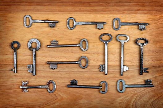 Old Keys Set on the Wooden Background