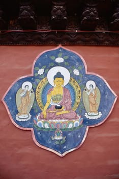 Yellow Buddha portrait painting on red wall , Nepal