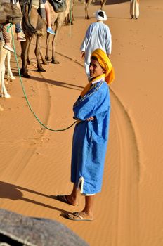 MERZOUGA DESERT - OCTOBER 01: Man in traditional Berber wear, walking in Merzouga Desert, Morocco on October 01, 2013.