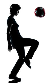 one  young teenager silhouette boy juggling soccer football full length in studio cut out isolated on white background