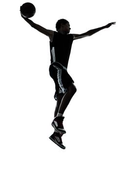 one young man basketball player dunking silhouette in studio isolated on white background