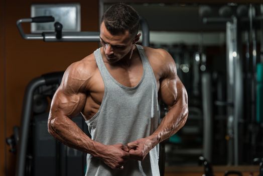 Portrait Of A Physically Fit Young Man - Flexing Muscles