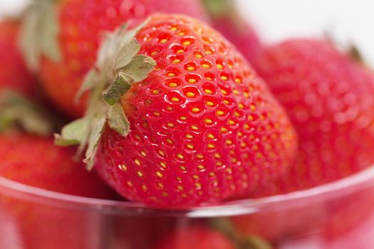 strawberry in a glass bowl isolated on white