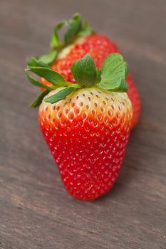 red juicy strawberry  on a wooden surface