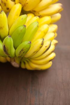 bunch of bananas on a wooden surface