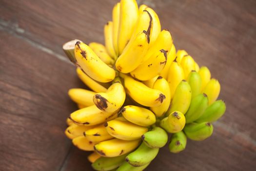 bunch of bananas on a wooden surface