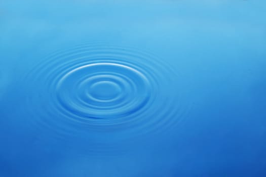 Wavy circles on the water, blue background
