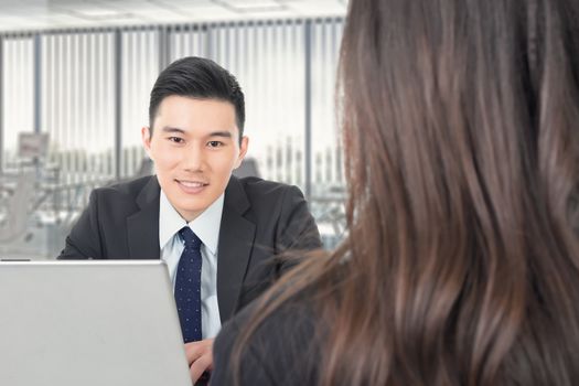 Asian young business man consulting with a woman, closeup portrait.