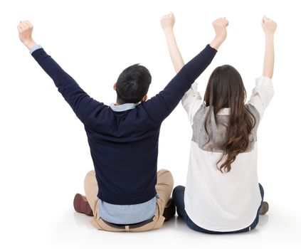 Asian couple sit on ground and open arms feel free, rear view on white background.