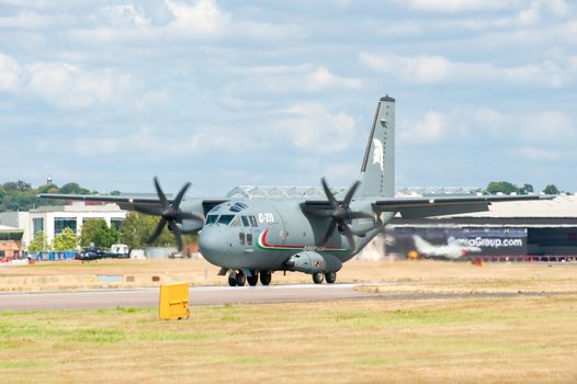 Farnborough, UK - July 24, 2010: Alenia C-27J Spartan military cargo plane thundering down the runway at the Farnborough Airshow, UK