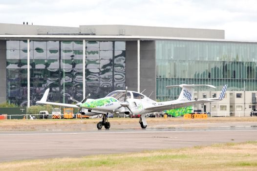 Farnborough, UK - July 24, 2010: Green energy aircraft - an EADS Diamond DA42, powered by algae biofuel on the runway at the Farnborough Airshow, UK