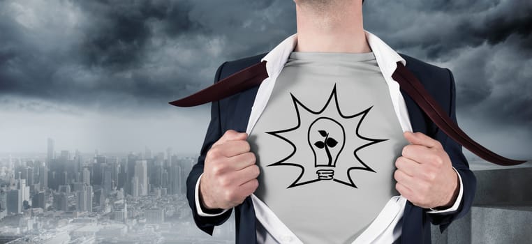 Businessman opening shirt in superhero style against coastline and city