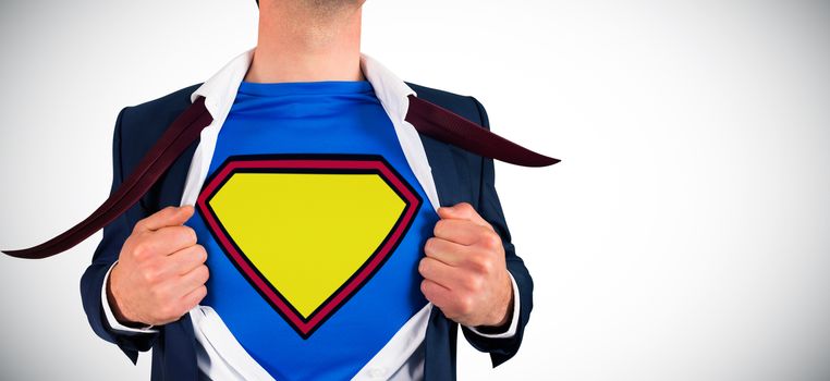 Businessman opening shirt in superhero style against white background with vignette