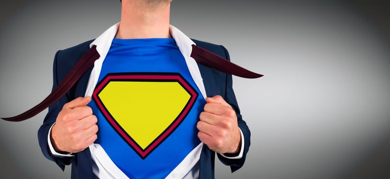 Businessman opening shirt in superhero style against grey vignette