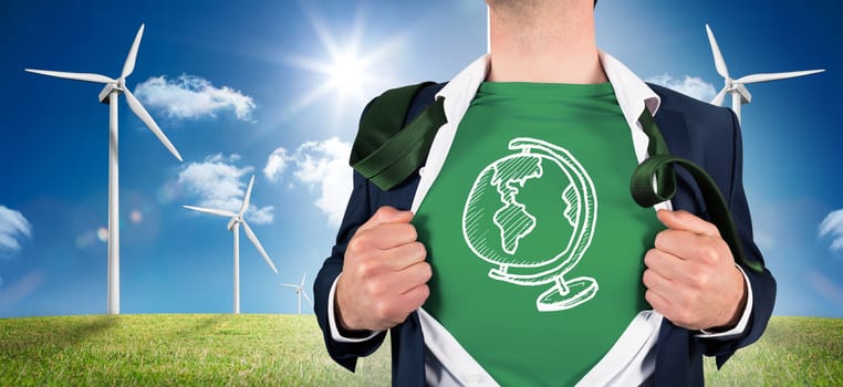 Businessman opening shirt in superhero style against digital landscape with three wind turbines
