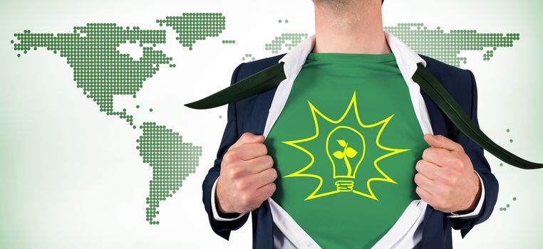 Businessman opening shirt in superhero style against green world map on white background