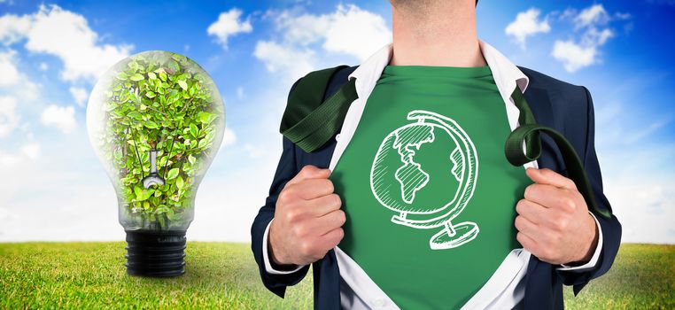 Businessman opening shirt in superhero style against light bulb with plant inside