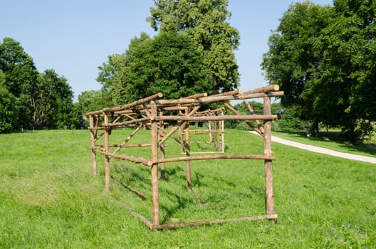 prepared wooden structure for rural market stalls and kiosks in green meadow