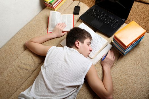 Teenager sleeps after Learning on the Sofa at the Home