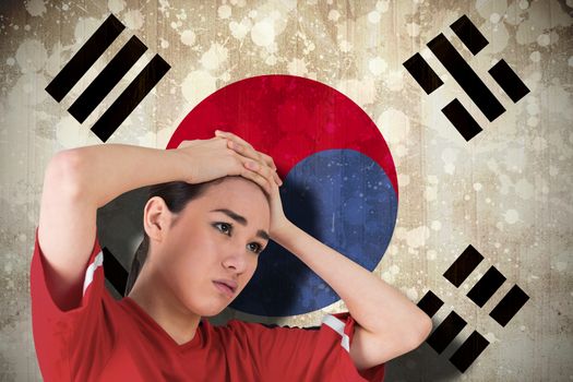 Disappointed football fan looking down against south korea flag