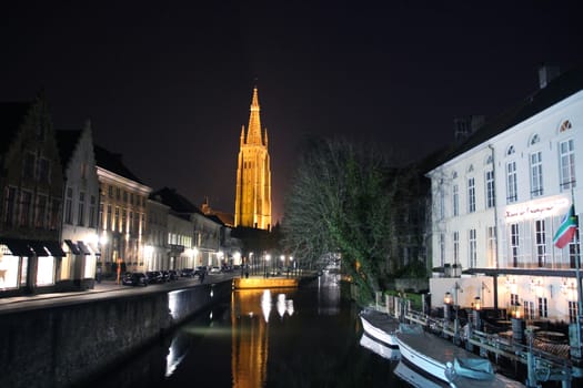 Tower of the Church Of Our Lady, brightly illuminated at night.