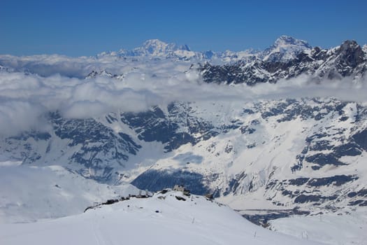 View across the Pennine Alps, in the foreground is Testa Grigia (3,479 m) is a rocky prominence above the Theodul Pass, located on the border between Italy and Switzerland.