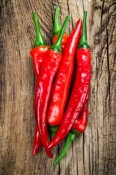 Chilli pepper on wooden table background. Top view