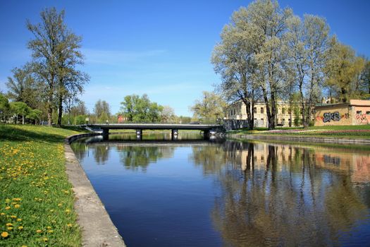 Landscape of a blue river and green field 