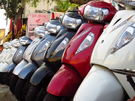 Suzuki Scooters for sale next to their most competing brand Honda shop in India                               