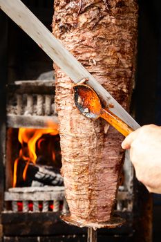 Shawarma meat being cut before making a sandwich