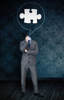 Composite image of headless businessman with jigsaw in speech bubble  against dark grimy room