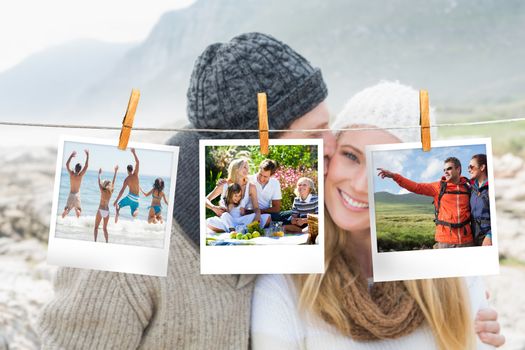 Composite image of instant photos hanging on a line against couple on the beach