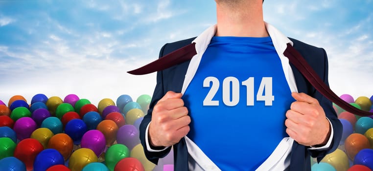 Businessman opening his shirt superhero style against many colourful balloons against sky