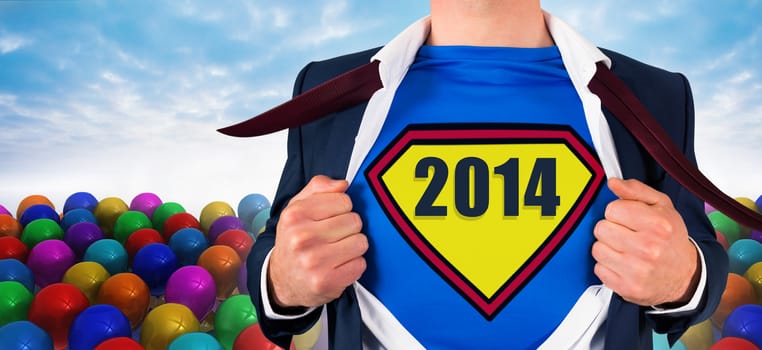 Businessman opening shirt in superhero style against many colourful balloons against sky