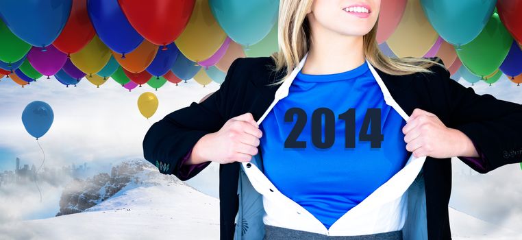 Businesswoman opening her shirt superhero style against many colourful balloons above snow