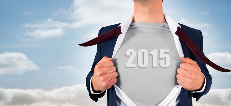 Businessman opening shirt in superhero style against view from balcony into bright sky