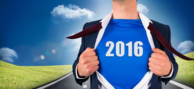 Businessman opening his shirt superhero style against road leading out to the horizon