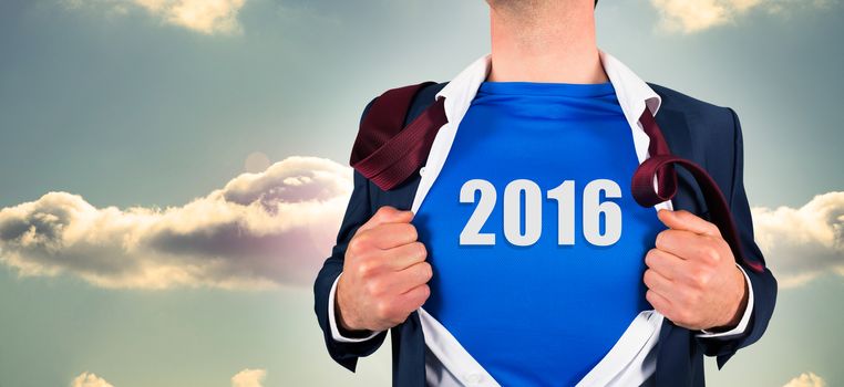 Businessman opening his shirt superhero style against bright blue sky with cloud