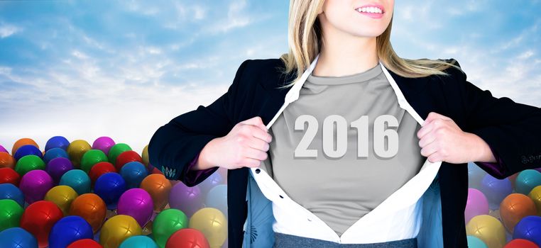 Businesswoman opening shirt in superhero style against many colourful balloons against sky