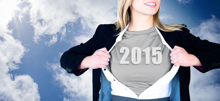 Businesswoman opening shirt in superhero style against blue cloudy sky
