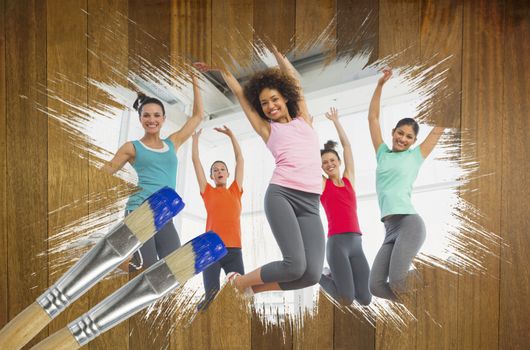 Composite image of fitness class at the gym with paintbrush dipped in blue against wooden surface with planks