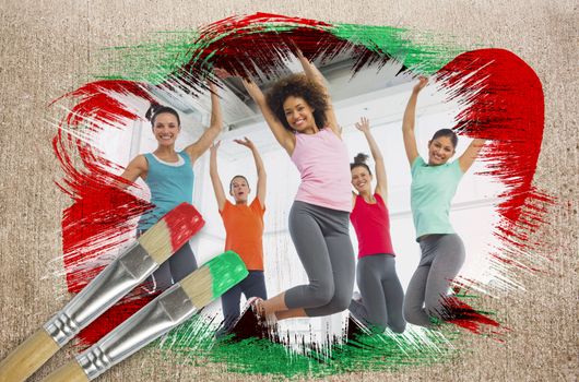Composite image of fitness class at the gym with paintbrush dipped in green against weathered surface 